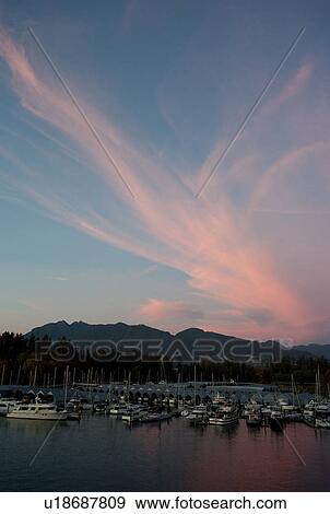 Stock Photo - Sunset skyline and boats docked in Vancouver, British Columbia, Canada. Fotosearch