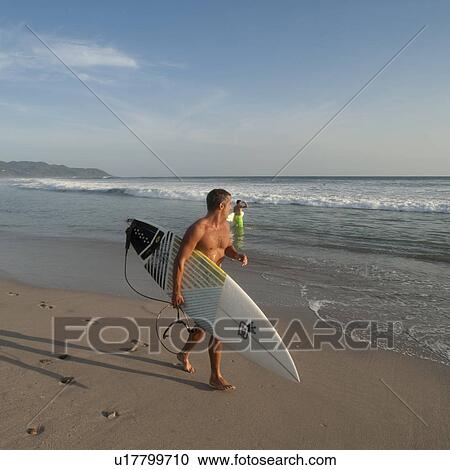 Surfer along Costa Rica beach View Large Photo Image Stock Image - Surfer along Costa Rica beach. Fotosearch