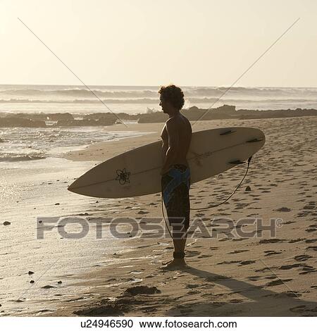 Surfer along Costa Rica beach View Large Photo Image Stock Image - Surfer along Costa Rica beach. Fotosearch