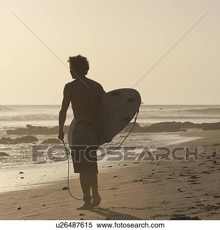 Surfer along Costa Rica beach View Large Photo Image Stock Photography - Surfer along Costa Rica beach. Fotosearch