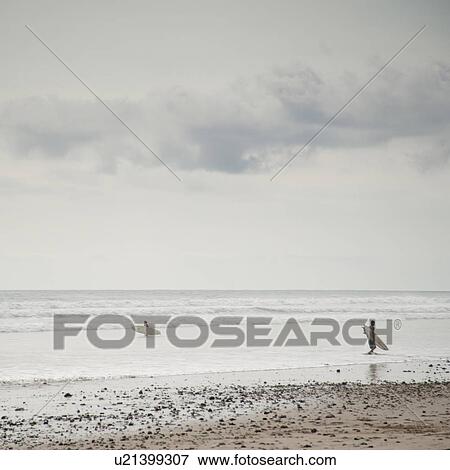 Surfer along ocean seashore in Costa Rica View Large Photo Image Stock Photo - Surfer along ocean seashore in Costa Rica. Fotosearch