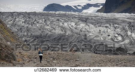 Terminus of glacier with girl to show scale View Large Photo Image Stock Photo - Terminus of glacier with girl to show scale. Fotosearch