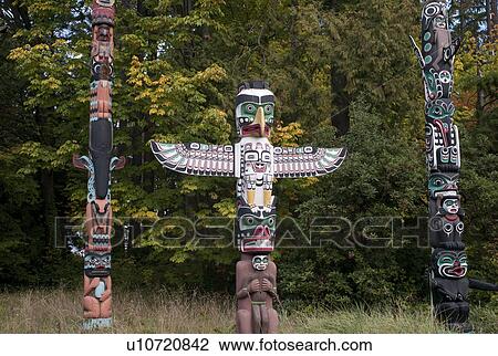 Stock Image - Totem Poles in Stanley Park in Vancouver, British Columbia, Canada. Fotosearch