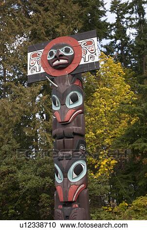 Stock Image - Totem Poles in Stanley Park in Vancouver, British Columbia, Canada. Fotosearch