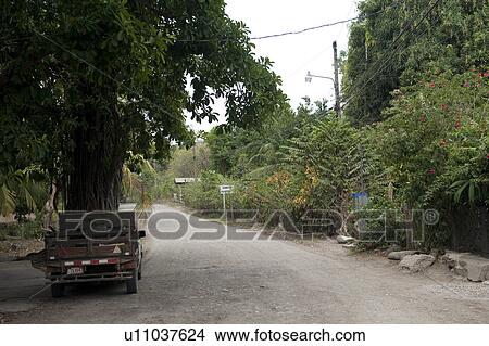 Treed rural road in the tropical forest of Costa Rica with a parked green pickup truck View Large Photo Image Picture - Treed rural road in the tropical forest of Costa Rica with a parked green pickup truck. Fotosearch