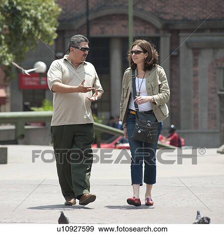 Stock Photo - Two people walking on the street in San Jose. Fotosearch