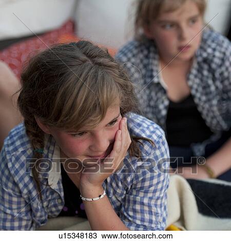 Stock Image - Two young girls looking off into the distance. Fotosearch