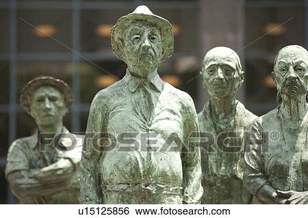 Verdigris bronze statues of agricultural workers standing in a crowd View Large Photo Image Stock Photograph - Verdigris bronze statues of agricultural workers standing in a crowd. Fotosearch