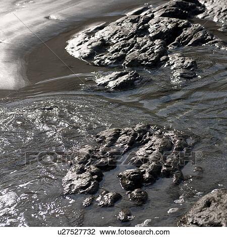 Water rippling amongst rocks on Coast Rica shoreline View Large Photo Image Stock Image - Water rippling amongst rocks on Coast Rica shoreline. Fotosearch