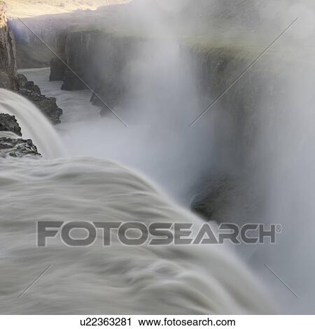 Waterfall into misty river valley View Large Photo Image Stock Image - Waterfall into misty river valley. Fotosearch
