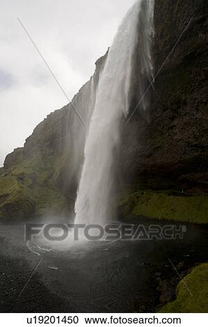 Waterfall over a cliff in Iceland View Large Photo Image Stock Image - Waterfall over a cliff in Iceland. Fotosearch