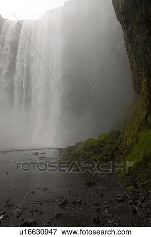 Stock Photo - Waterfall over a cliff in Iceland. Fotosearch