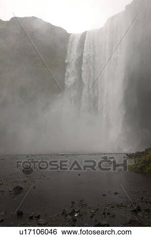 Stock Photograph - Waterfall over a cliff in Iceland. Fotosearch
