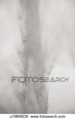 Stock Photography - Waterfall over rocky cliffs in Iceland. Fotosearch