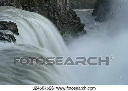 Waterfall through rugged terrain of rock and boulders View Large Photo Image Stock Photograph - Waterfall through rugged terrain of rock and boulders. Fotosearch