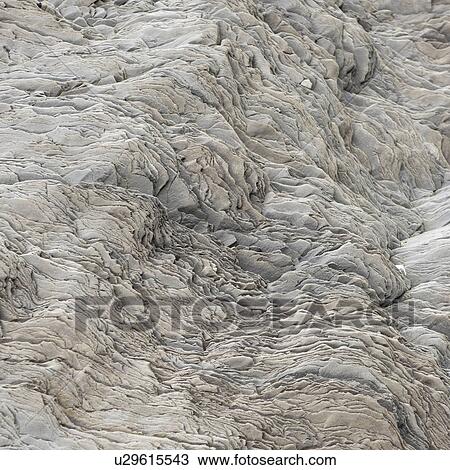 Stock Image - Wavy rock flake geological formation. Fotosearch