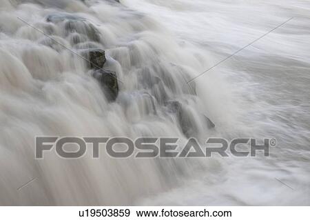 Stock Photo - White water cascading over rocks. Fotosearch