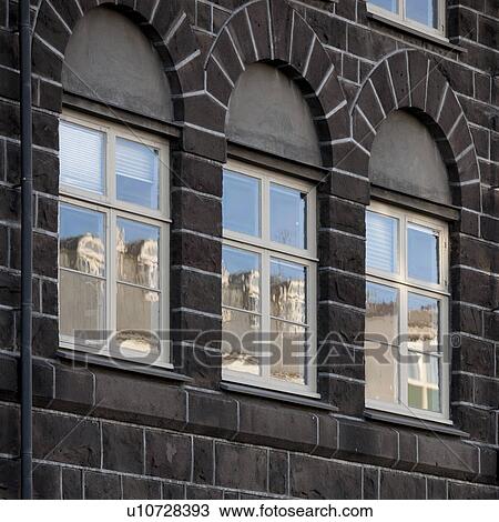 Windows in brick building reflecting buildings opposite View Large Photo Image Stock Image - Windows in brick building reflecting buildings opposite. Fotosearch