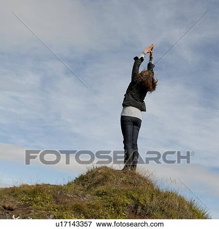 Woman having standing stretch on hilltop View Large Photo Image Stock Photo - Woman having standing stretch on hilltop. Fotosearch