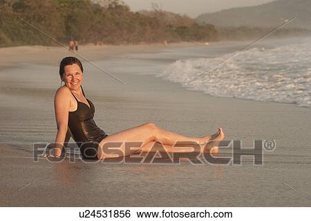 Woman on beach along Mal Pais coastline in San Jose Costa Rica View Large Photo Image Stock Photograph - Woman on beach along Mal Pais coastline in San Jose Costa Rica. Fotosearch