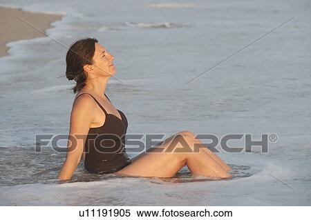 Stock Photography - Woman on beach along Mal Pais coastline in San Jose Costa Rica. Fotosearch