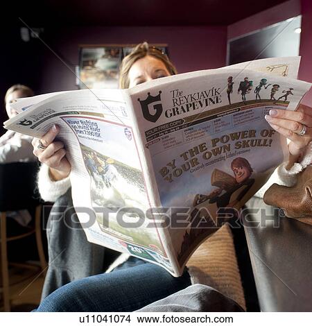 Woman reading open newspaper View Large Photo Image Picture - Woman reading open newspaper. Fotosearch