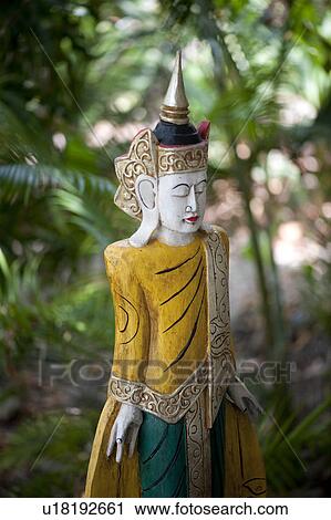 Wooden asian statue with ornate headpiece and large earlobes View Large Photo Image Stock Image - Wooden asian statue with ornate headpiece and large earlobes. Fotosearch