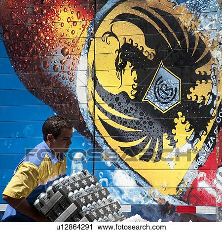 Stock Image - Worker unloading beverages in San Jose. Fotosearch