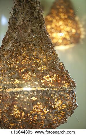 Stock Photography - Yellow spun glass pear shaped electric light fixture. Fotosearch