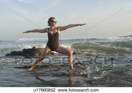 Stock Image - Yoga along Mal Pais coastline in San Jose Costa Rica. Fotosearch
