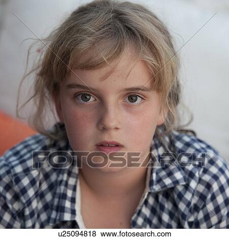Stock Photo - Young blond girl looking at the camera. Fotosearch
