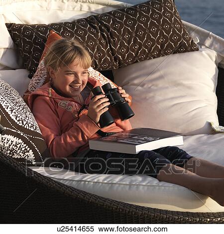 Young girl laughing and holding binoculars at Lake of the Woods, Ontario View Large Photo Image Stock Photography - Young girl laughing and holding binoculars at Lake of the Woods, Ontario. Fotosearch