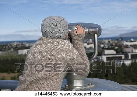 Young girl looking through binocular telescopic viewer at cityscape View Large Photo Image Stock Image - Young girl looking through binocular telescopic viewer at cityscape. Fotosearch
