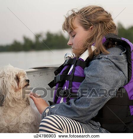 Young girl wearing a life jacket with her dog in Lake of the Woods, Ontario View Large Photo Image Stock Image - Young girl wearing a life jacket with her dog in Lake of the Woods, Ontario. Fotosearch