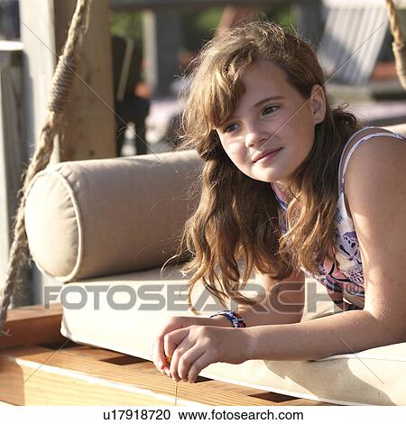 Stock Image - Young girl with a reflective look on her face at Lake of the Woods, Ontario. Fotosearch