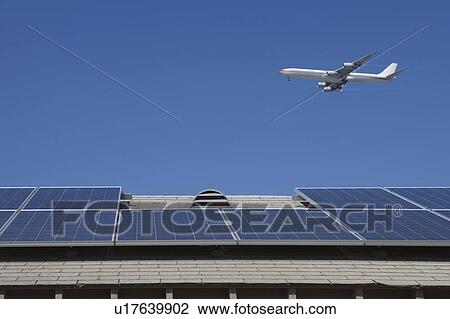 Stock Image - Aeroplane and rooftop with solar array, Inglewood, Los Angeles, California. Fotosearch