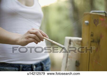 Stock Photo - Artists painting on canvas. Fotosearch