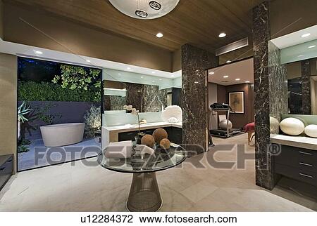 Stock Image - Bathroom with artwork of freestanding bath in California home. Fotosearch