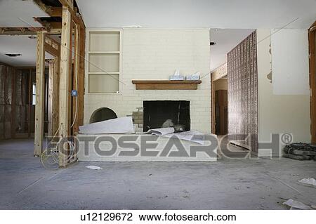 Stock Image - Brick fireplace and shelving in house renovation, Houston, Texas. Fotosearch