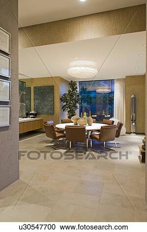 Stock Image - Lit dining area in California home. Fotosearch