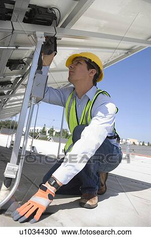Maintenance worker adjusting solar panel in Los Angeles, California View Large Photo Image Stock Image - Maintenance worker adjusting solar panel in Los Angeles, California. Fotosearch