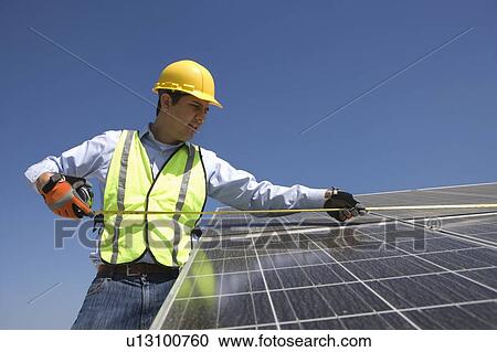 Maintenance worker measures solar cells in Los Angeles, California View Large Photo Image Stock Image - Maintenance worker measures solar cells in Los Angeles, California. Fotosearch