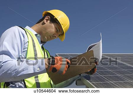 Picture - Maintenance worker with photovoltaic array in Los Angeles, California. Fotosearch