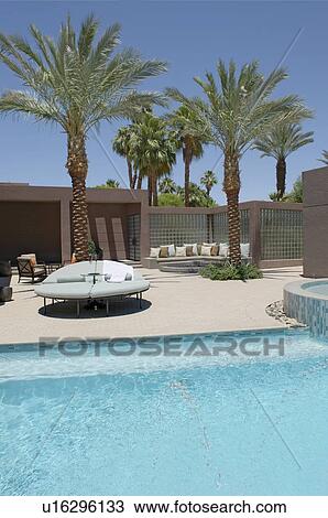 Seating with palm trees on poolside of Californian home View Large Photo Image Stock Image - Seating with palm trees on poolside of Californian home. Fotosearch