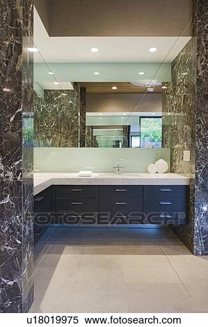 Stock Photography - Storage units and mirror in bathroom of California home. Fotosearch