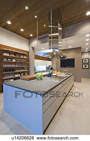 Stock Photo - Wood panelled spotlit kitchen in California home. Fotosearch