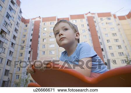 Stock Image - Young boy in playground. Fotosearch