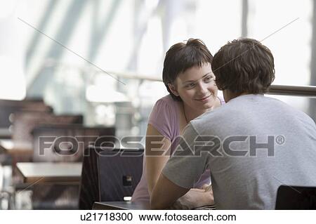 Stock Image - Young couple sit in food hall of shopping mall, Voronezh. Fotosearch