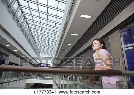 Stock Image - Young woman in shopping centre, Voronezh. Fotosearch