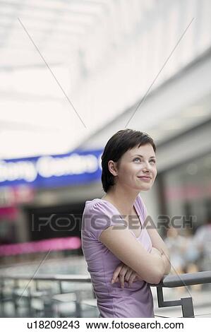 Stock Image - Young woman in shopping centre, Voronezh. Fotosearch